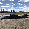 Black 2026 Rainbow Trailers 22' Excursion Tilt Deck Trailer - GVWR: 7000lbs