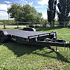 Black 2026 Rainbow Trailers 18' Excursion Tilt Deck Trailer