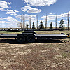 Black 2026 Rainbow Trailers 22' Excursion Tilt Deck Trailer