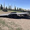 Black 2026 Rainbow Trailers 20' Excursion Tilt Deck Trailer