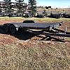 Black 2027 Rainbow Trailers 22' Excursion Tilt Deck Trailer 2x5200 lb Axles at FM Trailer World