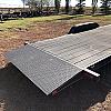 Black 2027 Rainbow Trailers 22' Excursion Tilt Deck Trailer 2x5200 lb Axles at FM Trailer World
